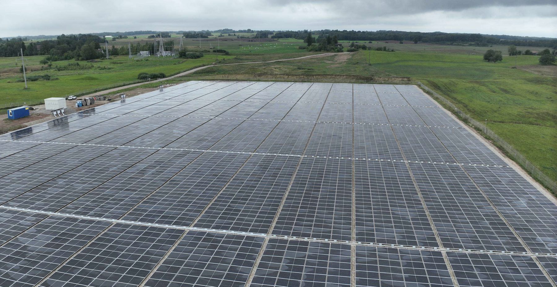 Drone view of the Skiemonys flat-mount solar park with the substation behind